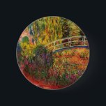 Monet Water Lily Pond and Water Irises 6 Cm Round Badge<br><div class="desc">Button featuring Claude Monet’s oil painting of a Japanese bridge and beautiful flowers. Water lily pond and water irises bathed in pink light. Serene nature impressionism with lovely flowers and scenic pond landscape. A great Monet gift for fans of impressionism and French art.</div>