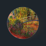 Monet Water Lily Pond and Water Irises 6 Cm Round Badge<br><div class="desc">Button featuring Claude Monet’s oil painting of a Japanese bridge and beautiful flowers. Water lily pond and water irises bathed in pink light. Serene nature impressionism with lovely flowers and scenic pond landscape. A great Monet gift for fans of impressionism and French art.</div>