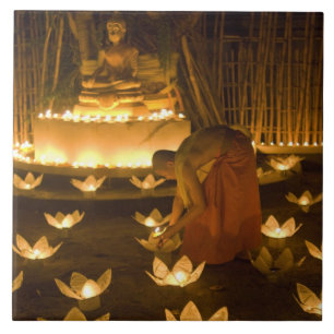 Monks lighting khom loy candles and lanterns for ceramic tile