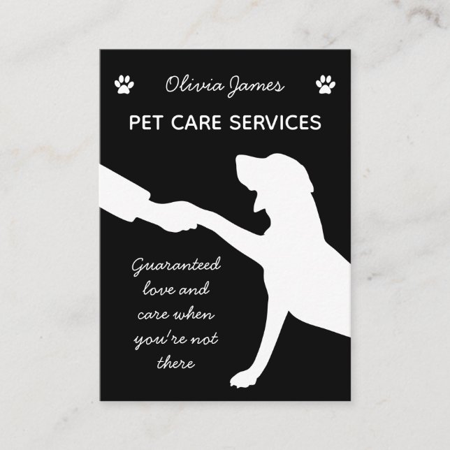 Monochrome dog paw in hand pet care services business card (Front)