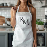 Monogram Black Minimal Apron<br><div class="desc">Elevate your kitchen style with this Monogram Black Minimalist Apron. Featuring a sleek and simple design, this apron combines functionality with elegance, making it perfect for both home cooks and professional chefs. The customisable monogram adds a personal touch, ensuring that you cook in style. Made from durable materials, this apron...</div>