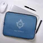Monogram Classic Blue Vintage Elegant Crest Name Laptop Sleeve<br><div class="desc">A classic blue and silver design with the monogram initial in a vintage crest, recommended for a man. The crest is faux silver foil, the background is classic blue. Under the crest there is the name in grey caps. The vintage floral crest from an old book cover binding, of the...</div>