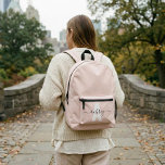 Monogram Name Script Blush Pink Printed Backpack<br><div class="desc">Get ready for school with this stylish personalized backpack! Featuring your name in whimsical calligraphy, beautifully overlaying your monogram in a bold, modern font, this backpack combines practicality with a unique touch. Spacious and durable, it's perfect for carrying all your essentials—from textbooks to notebooks—while showcasing your personal style. Whether for...</div>