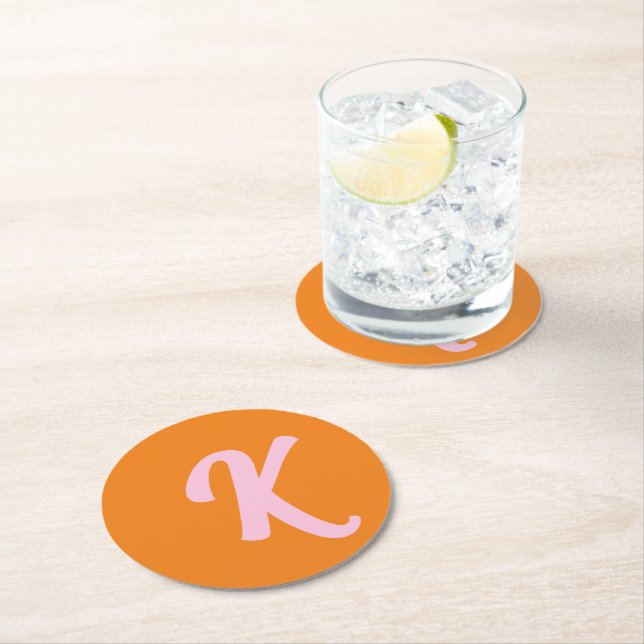 Monogram orange and pink round paper coaster (Insitu)