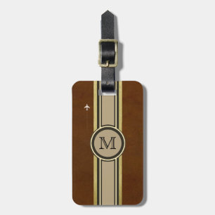 monogram to identify a brown suitcase . luggage tag