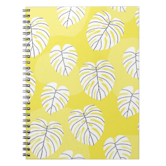 Monstera leaves, bright yellow background. notebook
