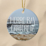 Morro Bay California Ocean Waves Photography Ceramic Ornament<br><div class="desc">A gorgeous overcast day in Morro Bay California brings cool ocean waves to the shore in this coastal photograph. This pretty seaside Christmas ornament features white script over the beach rocks and grey sky.</div>