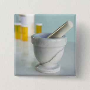 Mortar and pestle, pill bottles in background 15 cm square badge