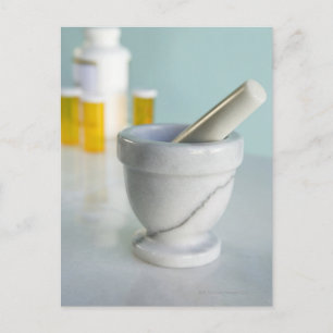 Mortar and pestle, pill bottles in background postcard
