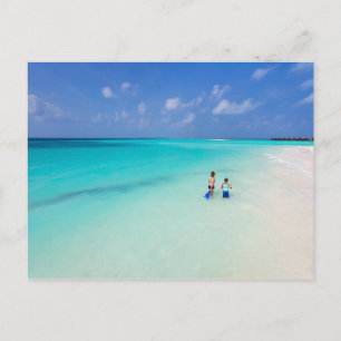 Mother and son at tropical beach postcard