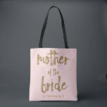 Mother of the Bride Gold Glitter Blush PInk Tote Bag<br><div class="desc">This Mother of the Bride tote bag is perfect for proud moms to tote around all their belongings at the bridal shower or the main event. This blush pink tote bag features faux gold glitter style lettering on the front. Personalise these totes with your wedding party member's name on the...</div>