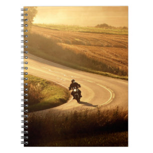 Motorcycle on countryside road at autumn evening. notebook