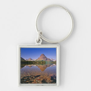 Mountains reflect into calm Two Medicine Lake in Key Ring