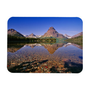 Mountains reflect into calm Two Medicine Lake in Magnet