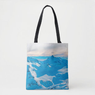 Mountains with snow peaks and sunset skysnow,alpin tote bag