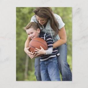 MR mother (age 26) playing basketball with son Postcard