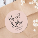 Mr Mrs Blush Pink Wedding Classic Round Sticker<br><div class="desc">A chic blush pink sticker for your wedding correspondence and party favours featuring "Mr & Mrs" written in a large script and an illustration of two hearts joined together. Add your name and wedding date.</div>