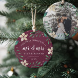 Mr. & Mrs. | First Married Christmas Photo Ceramic Ornament<br><div class="desc">Celebrate your first Christmas as a married couple with this charming and festive ornament. Design features "our first Christmas as Mr. & Mrs." and the year in white lettering, surrounded by ivory poinsettia flowers and green holiday foliage on a plum background. Add a photo to the back with matching holiday...</div>