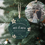 Mr. & Mrs. | First Married Christmas Photo Ceramic Ornament<br><div class="desc">Celebrate your first Christmas as a married couple with this charming and festive ornament. Design features "our first Christmas as Mr. & Mrs." and the year in white lettering, surrounded by ivory poinsettia flowers and green holiday foliage on a hunter green background. Add a photo to the back with matching...</div>