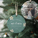 Mr. & Mrs. | First Married Christmas Photo Ceramic Ornament<br><div class="desc">Celebrate your first Christmas as a married couple with this charming and festive ornament. Design features "our first Christmas as Mr. & Mrs." and the year in white lettering, surrounded by ivory poinsettia flowers and green holiday foliage on a spruce green background. Add a photo to the back with matching...</div>