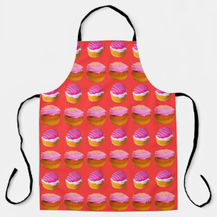 Muffins, cupcakes with white and pink cream on a r apron