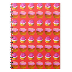 Muffins, cupcakes with white and pink cream on a r notebook