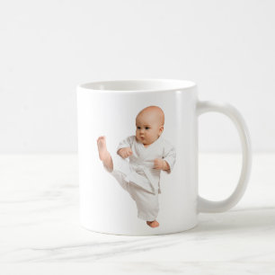 Mug baby karateka in his white kimono.
