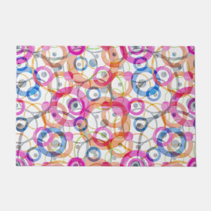 Multi-coloured polka dots, circles on a white doormat