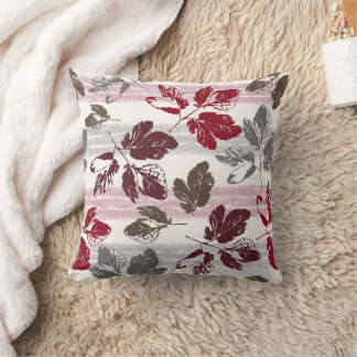 Multicolored leaves on a striped background. cushion