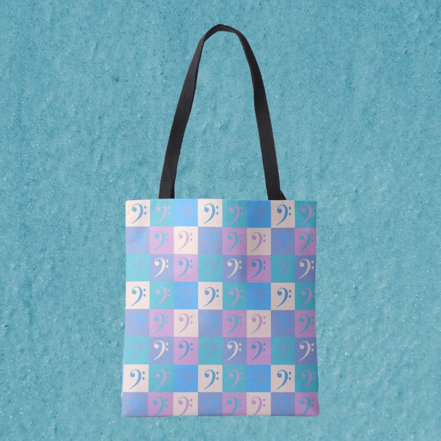 Music Bass Clef Pastel Pattern Tote Bag (An all over print tote bag featuring a pattern of bass clefs in yellow, pink, purple and blue.)