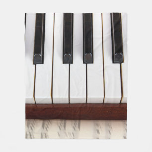 musical notes on the background of a pianoacoustic fleece blanket