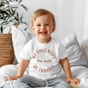 My smile keeps me out of trouble  baby T-Shirt