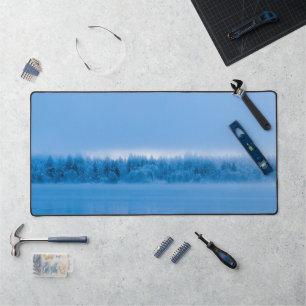 Mysterious fog over snowy lake Bohinj, Slovenia Desk Mat
