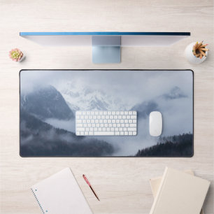 Mysterious fog rolling through layers of hills desk mat