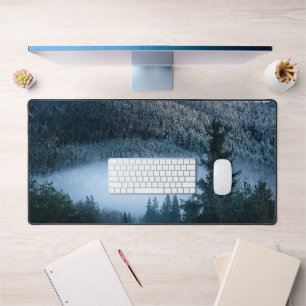 Mysterious fog trapped in winter spruce forest desk mat