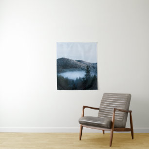 Mysterious fog trapped in winter spruce forest tapestry