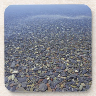 NA, USA, Montana, Glacier NP Rocks in Lake Coaster