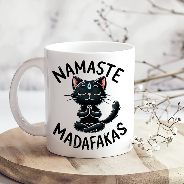 "Namaste Madafakas" Funny Cat Lovers Coffee Mug ("Namaste Madafakas" Funny Cat Lovers Coffee Mug on a boho kitchen table with tiny white flowers)