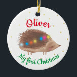 Name Cute Hedgehog Baby First Christmas  Ceramic Ornament<br><div class="desc">Personalised baby first Christmas ornament,  featuring cute decorated hedgehog illustration on a white background,  with small little gold dottie snowflakes. Baby boy or baby girl custom name first Christmas design.</div>