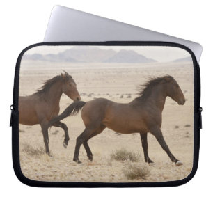 Namibia, Aus. Wild horses running on the Namib Laptop Sleeve