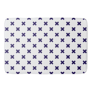 Navy blue cross stitches on white bath mat