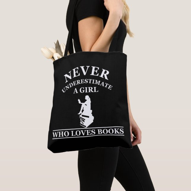 never underestimate a girl who loves books tote bag (Close Up)