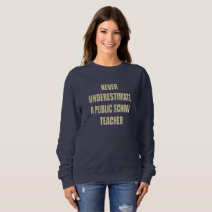 never underestimate a public school teacher sweatshirt
