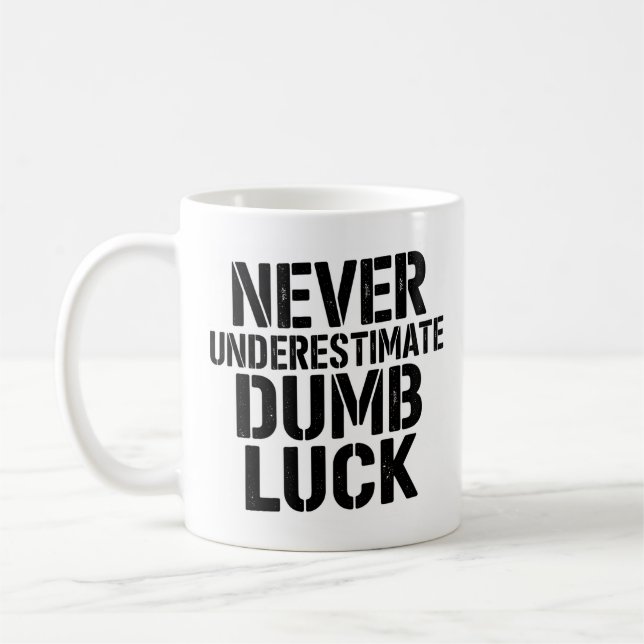 "Never Underestimate Dumb Luck" Saying Coffee Mug (Left)