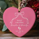 New Baby Announcement Christmas  Ceramic Ornament<br><div class="desc">Celebrate the joy of new beginnings with our personalised Christmas ornament featuring adorable baby footprints. This charming keepsake is perfect for announcing a new baby girl to Grandma and Grandpa, making it a heartfelt addition to their holiday decor. Adorned with a hand-drawn heart and a coquette ribbon bow. A unique...</div>