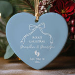New Baby Announcement Christmas  Ceramic Ornament<br><div class="desc">Celebrate the joy of new beginnings with our personalised Christmas ornament featuring adorable baby footprints. This charming keepsake is perfect for announcing a new baby boy to Grandma and Grandpa, making it a heartfelt addition to their holiday decor. Adorned with a hand-drawn heart and a coquette ribbon bow. A unique...</div>