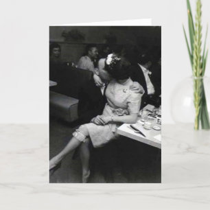 newlyweds kissing to a resturaunt card