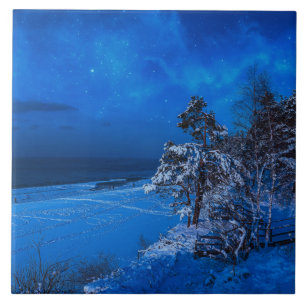 Nighttime winter scene with snow covered pines ceramic tile