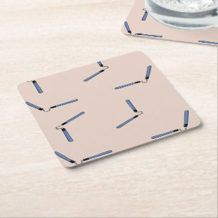 Ninja nunchaku on brown square paper coaster