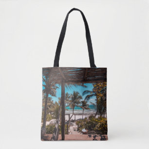 Nipa hut under coconut palm trees tote bag